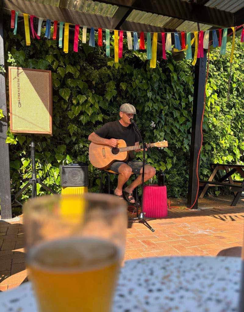Ryan Edwards playing an acoustic set outdoors